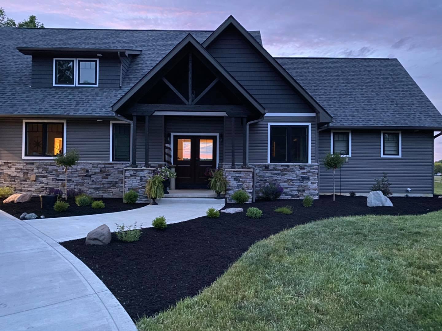 Finished lawn and landscaping at a dark modern home